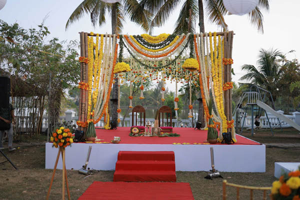 Marigold and bamboo outdoor wedding stage 